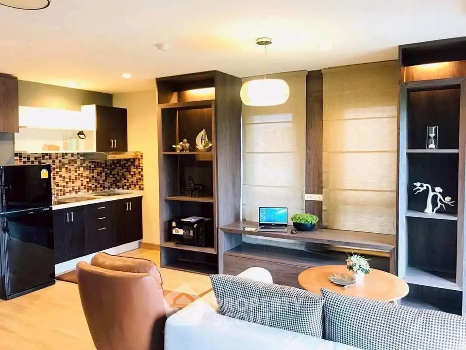 Modern living room with stylish decor, open kitchen, and cozy seating area in a contemporary apartment.