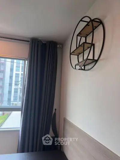 Modern bedroom with stylish wall shelf and large window view.
