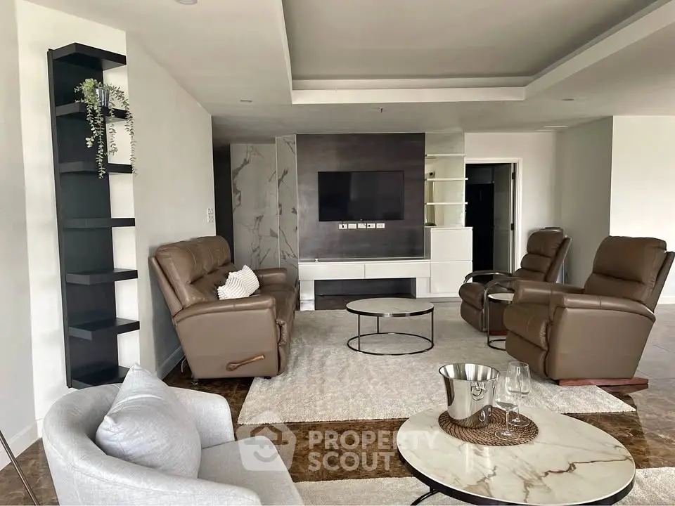 Spacious modern living room with leather recliners and sleek decor