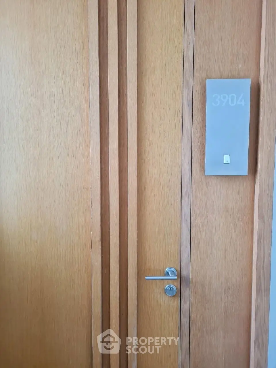 Elegant wooden apartment door with modern design and room number 3904.