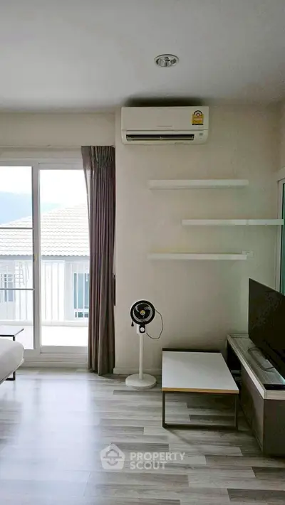 Modern living room with air conditioning and balcony view in a stylish apartment.