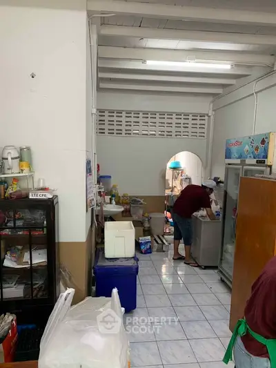 Cozy kitchen with tiled floor and fridge, perfect for home cooking enthusiasts.