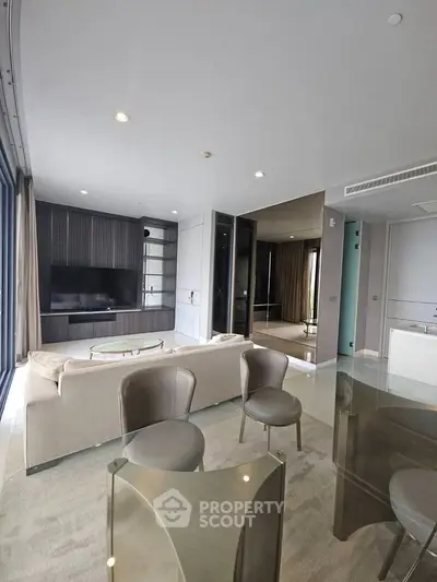 Modern living room with sleek furniture and large TV, perfect for relaxation and entertainment.