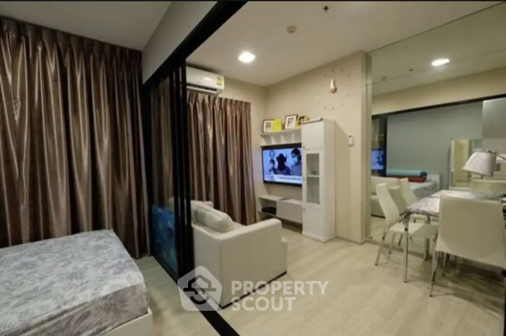 Modern studio apartment with cozy living area and dining space