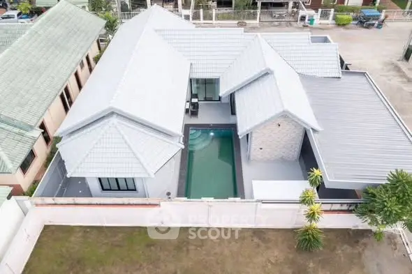 Stunning aerial view of modern home with private pool and spacious layout.