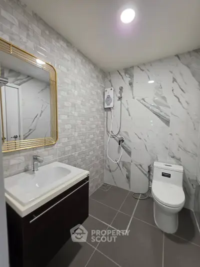 Modern bathroom with marble tiles and sleek fixtures