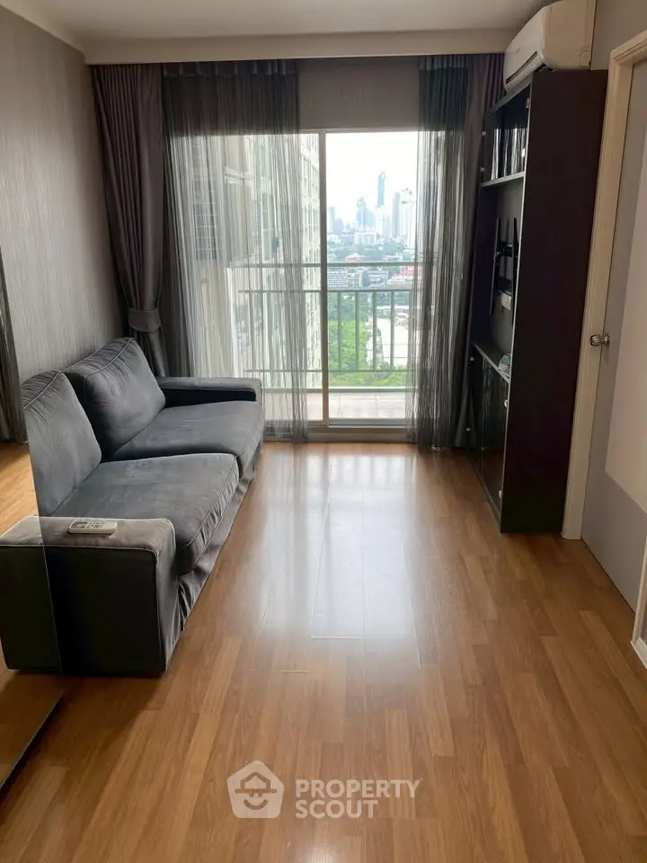 Modern living room with city view, sleek sofa, and wooden flooring, perfect for urban living.