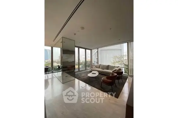 Luxurious modern living room with floor-to-ceiling windows and elegant furnishings in a high-rise apartment.