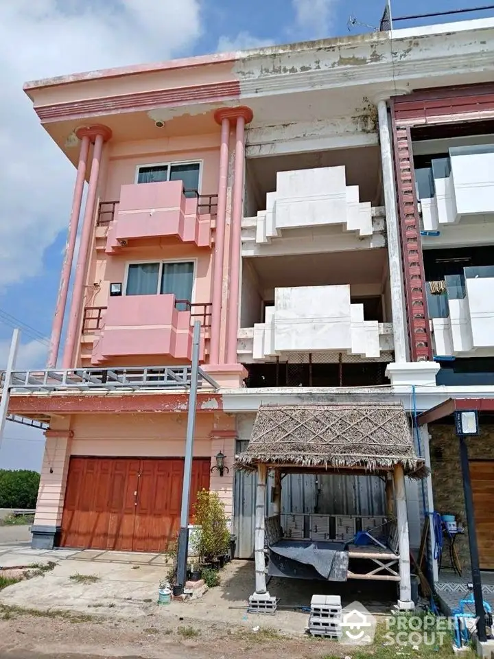 Charming three-story building with unique architectural design and spacious balconies.