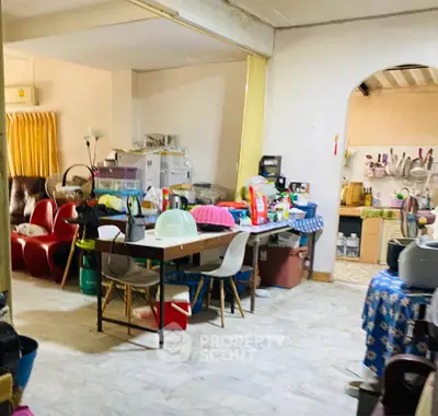 Spacious living area with open kitchen layout and ample natural light.