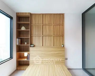 Modern minimalist bedroom with wooden accents and large window view.