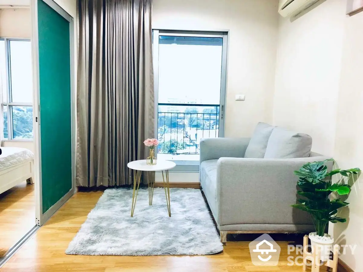 Bright and cozy living room with modern furnishings, plush rug, and balcony access, perfect for urban living.