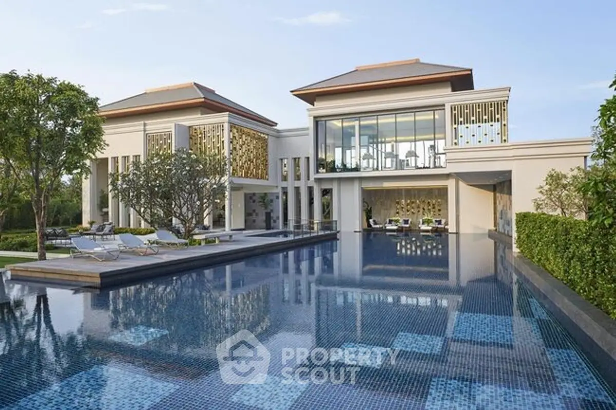 Luxurious modern villa with expansive pool and elegant architecture.