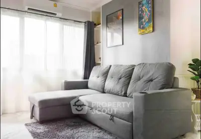 Modern living room with stylish gray sofa and natural light