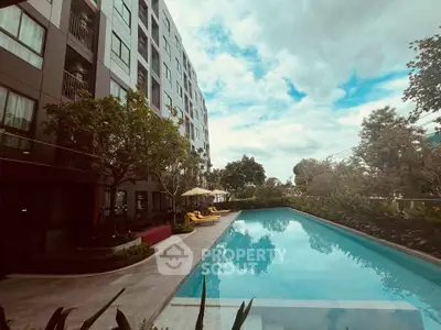 Luxurious apartment building with a stunning outdoor pool and lush greenery, perfect for relaxation and leisure.