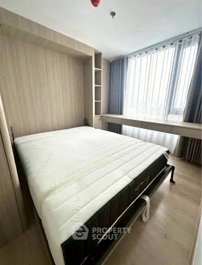 Modern bedroom with large window and natural light