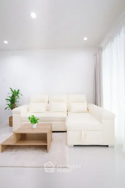 Bright living room with white sofa and modern decor