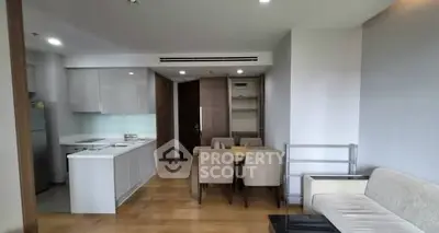 Modern open-plan living room and kitchen with sleek design and dining area.