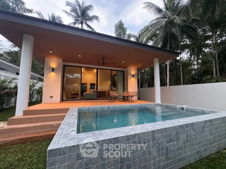 Stunning modern villa with private pool and spacious terrace surrounded by lush greenery.