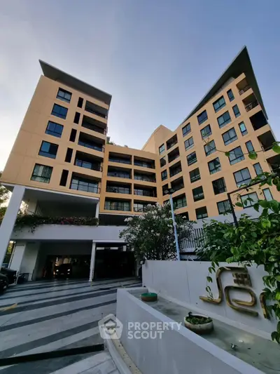 Modern apartment building with unique architecture and lush greenery