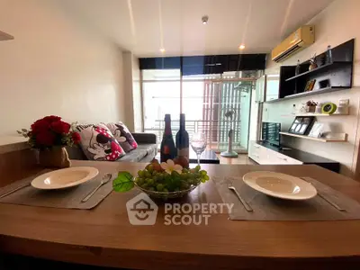 Stylish living room with dining area and balcony view, perfect for modern urban living.