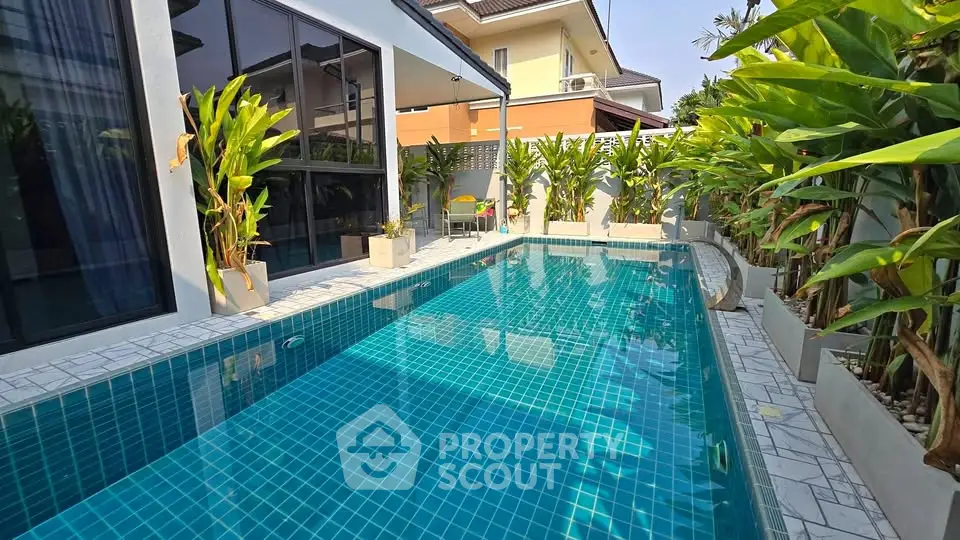 Luxurious private pool with modern design and lush greenery in a serene residential setting.