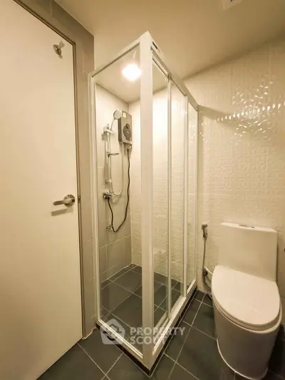 Modern bathroom with sleek shower enclosure and contemporary fixtures.