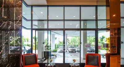 Luxurious building entrance with modern glass facade and stylish seating area.