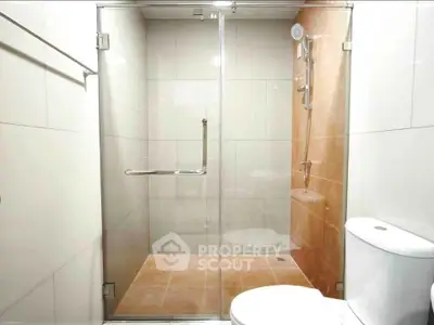 Modern bathroom with glass shower enclosure and sleek fixtures