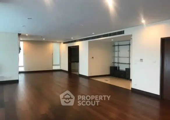 Spacious modern living room with wooden flooring and recessed lighting