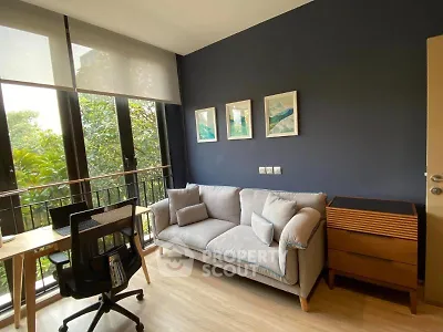 Chic living room with modern decor and lush garden view, perfect for relaxation and productivity.
