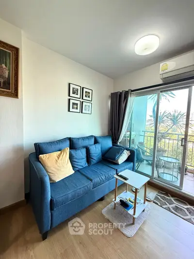 Cozy living room with blue sofa and balcony view