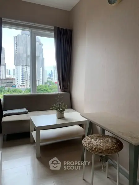 Cozy living room with city view, modern furniture, and natural light.