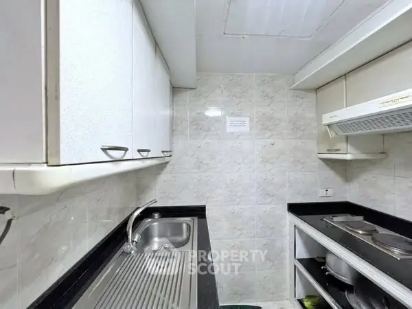 Compact kitchen with sleek cabinets and modern appliances