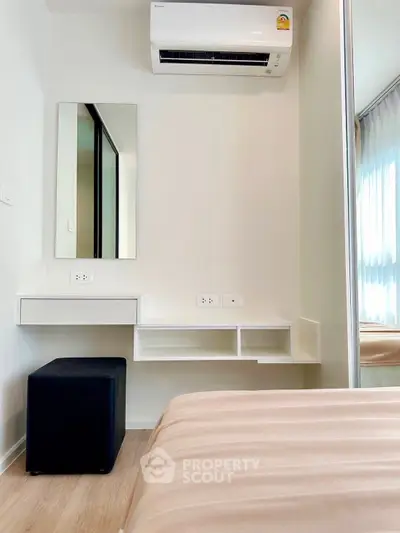 Modern bedroom with sleek air conditioning and stylish vanity area, perfect for comfort and elegance.