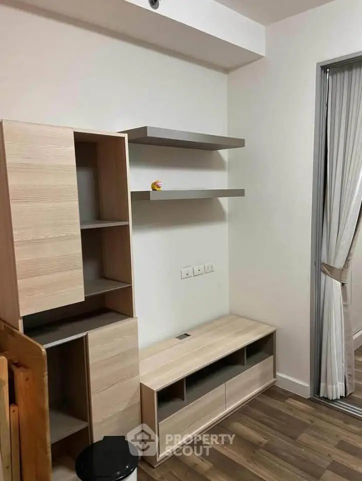 Modern living room with stylish wooden furniture and sleek shelving, perfect for contemporary living.