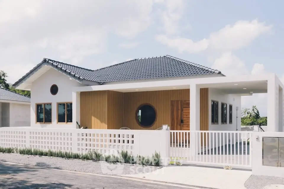 Modern single-story house with stylish facade and spacious front yard.