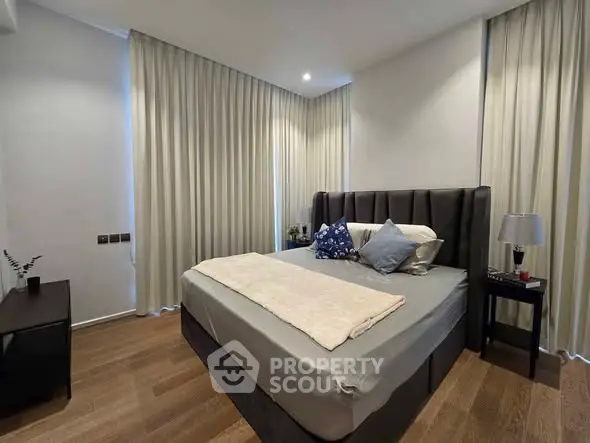 Luxurious bedroom with elegant decor and plush bedding in modern apartment.