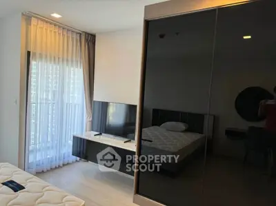 Modern bedroom with sleek furniture and large window for natural light