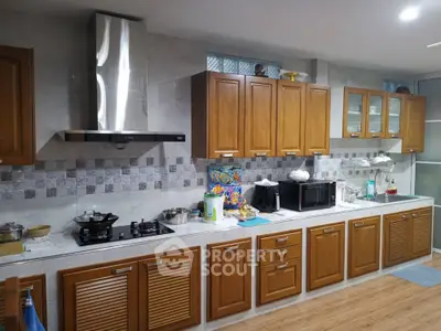 Spacious kitchen with wooden cabinets and modern appliances