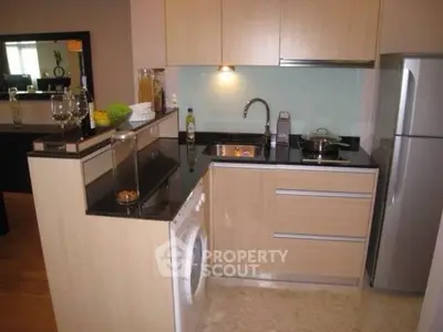 Modern kitchen with sleek cabinetry and built-in appliances in a stylish apartment.
