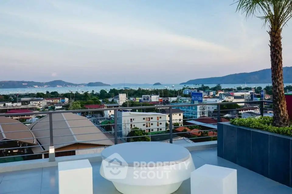 Stunning rooftop view with ocean and cityscape, perfect for relaxation and entertainment.