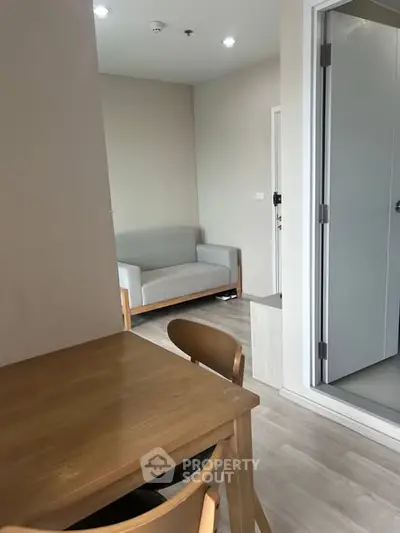 Cozy apartment interior with wooden dining set and modern sofa