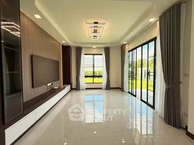 Spacious modern living room with large windows and elegant ceiling design