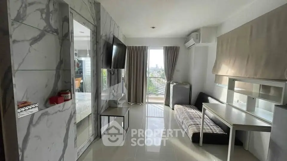 Modern living room with marble accents and city view balcony in a stylish apartment.