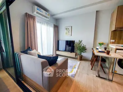 Modern living room with cozy sofa, large TV, and stylish decor in a bright apartment.
