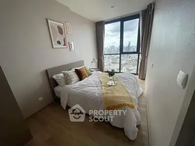 Cozy bedroom with city view, featuring a stylish bed and modern decor, perfect for urban living.