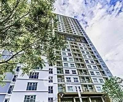 Stunning high-rise building with modern architecture and lush greenery