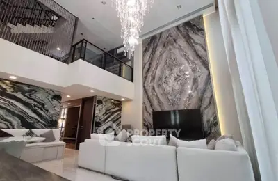 Luxurious living room with high ceilings and elegant marble accents