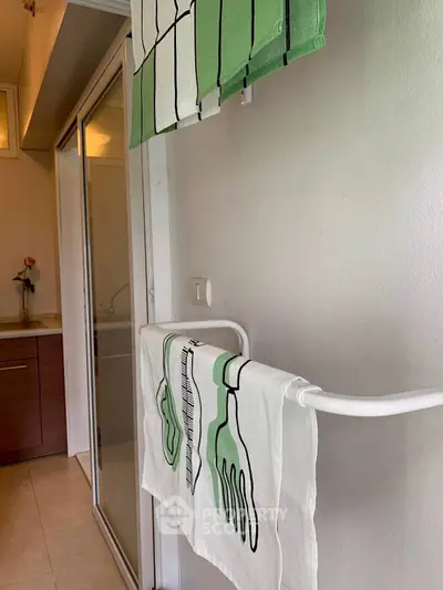 Modern bathroom with stylish towels and sleek glass shower door